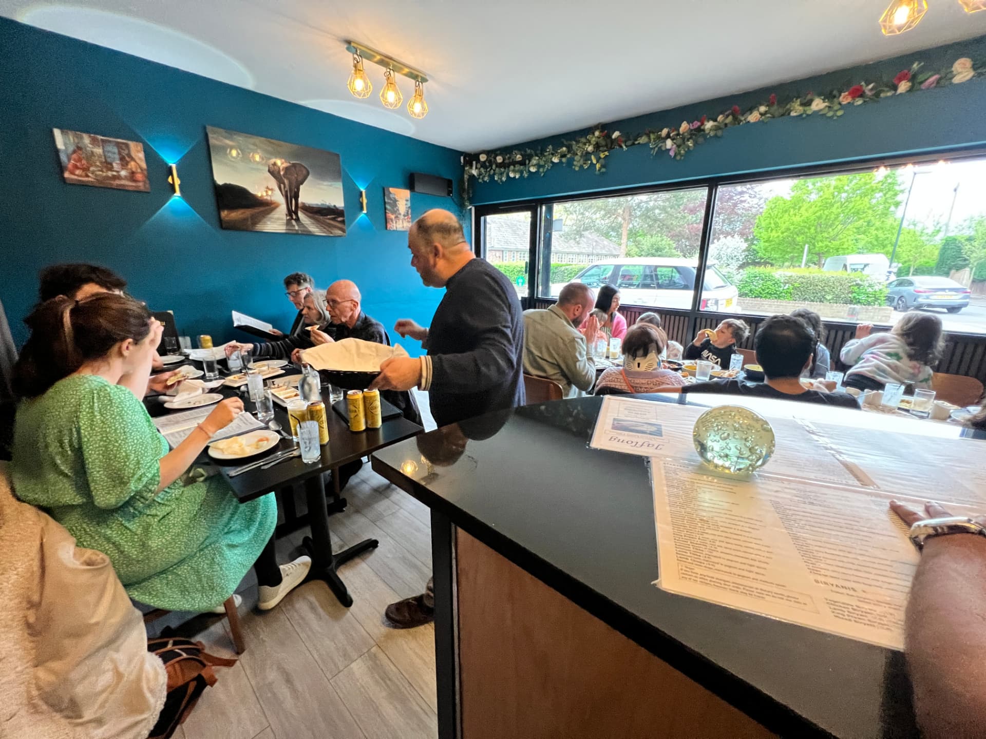 Busy evening service in the Jaflong Tandoori dining room with guests at every table