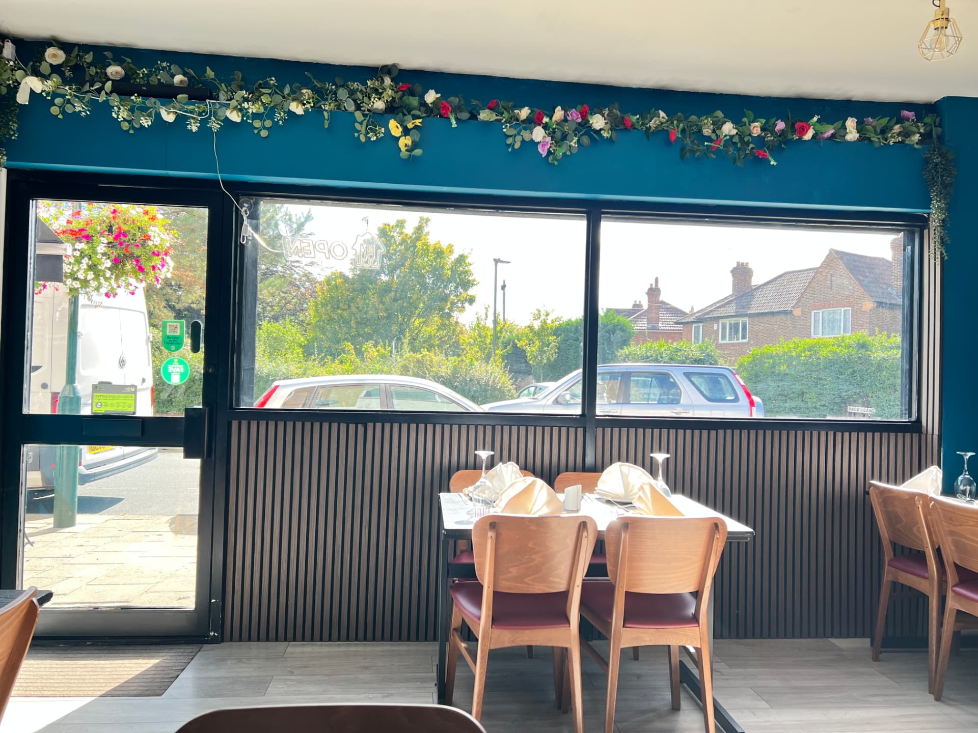 Jaflong Tandoori newly renovated dining room with tables set by the window