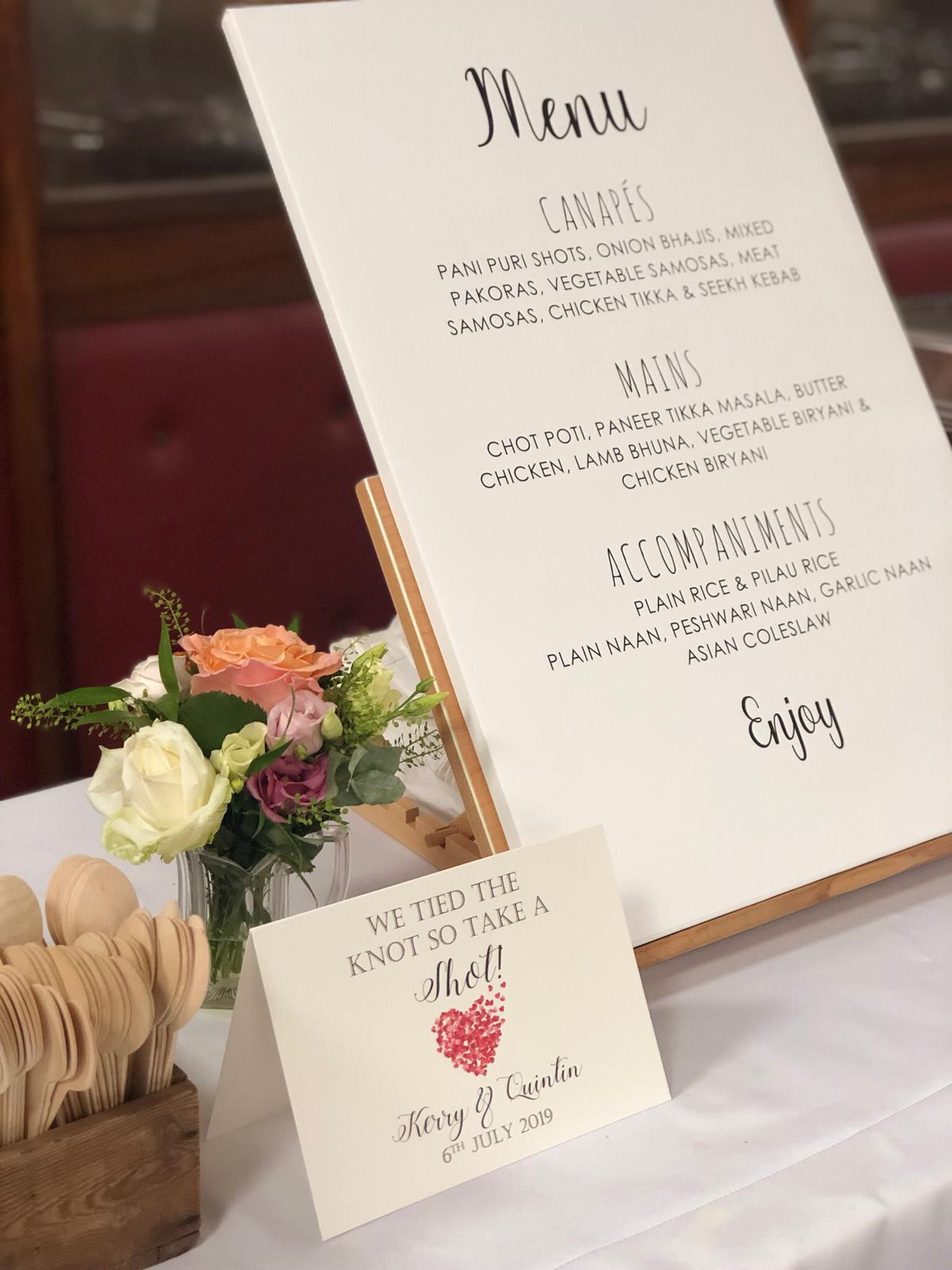 Printed wedding menu board listing canapés, mains and accompaniments catered by Jaflong Tandoori