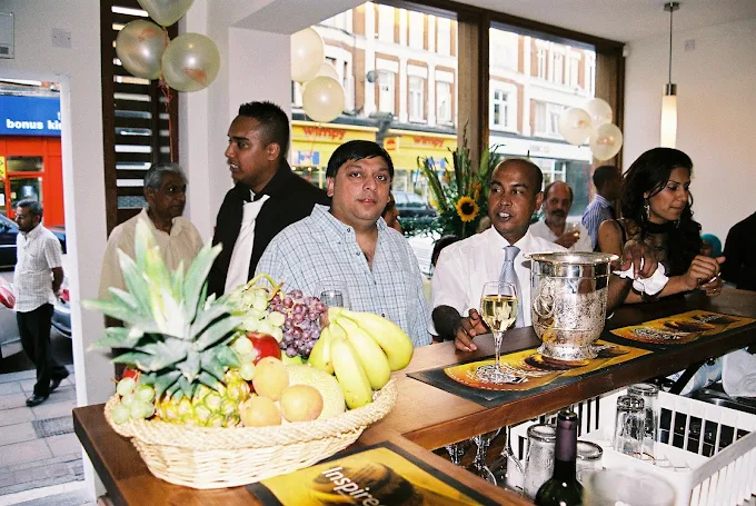 Syed Bashar, proprietor of Jaflong Tandoori, with family and guests in the restaurant